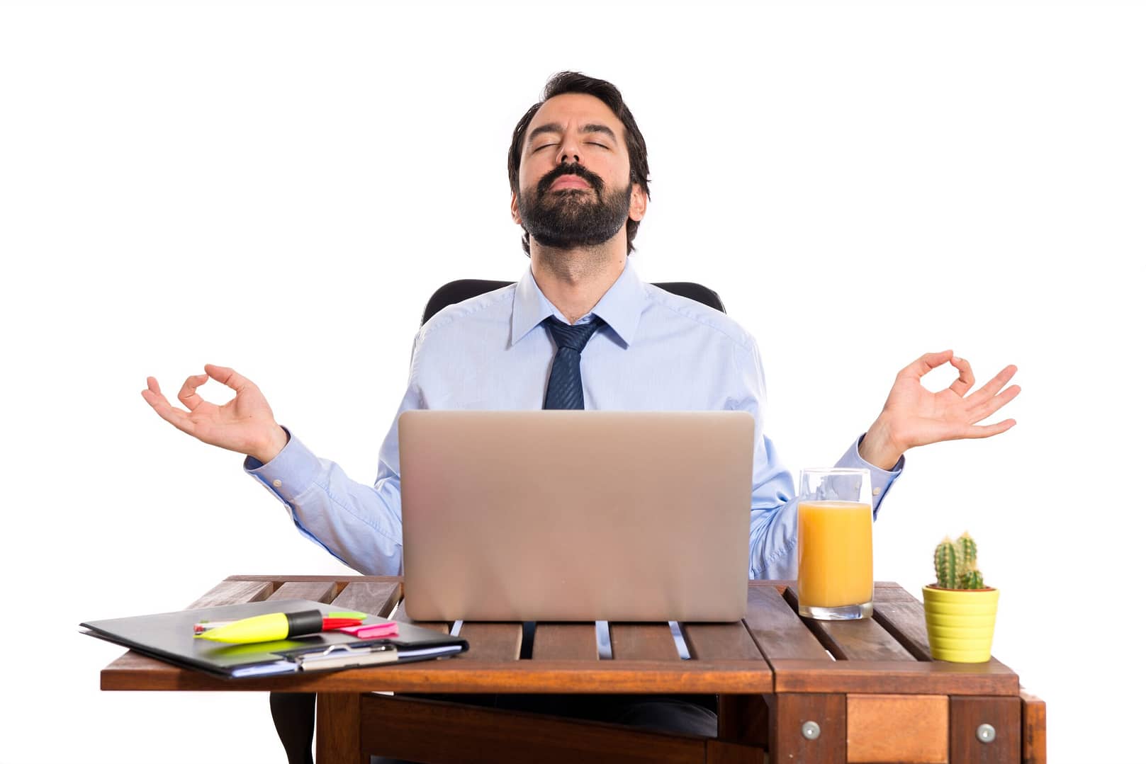 Businessman in his office with Zen pose